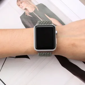 Close-up detail of a woven nylon elastic replacement watch band worn on wrist, textured style.