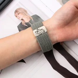 Gray braided nylon elastic Apple Watch strap with a cute cat metal buckle detail view.