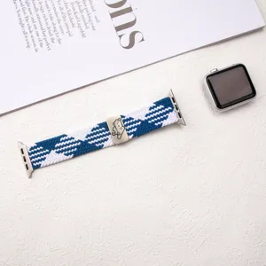 Close-up of elastic woven nylon watch strap with blue white pattern and cute cat metal buckle.