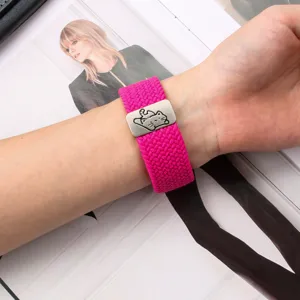 Close-up detail of hot pink woven nylon watch strap featuring a cute cat metal magnetic buckle.