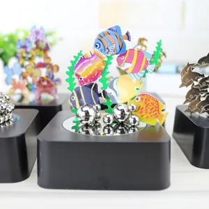 Magnetic colorful fish desktop ornament detail shot, creative metal sculpture decor.