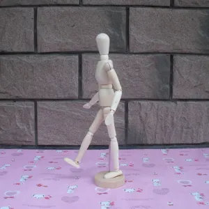 Wooden artist mannequin detail showing flexible joints and stable base for sketching and drawing art.