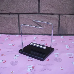 Detailed view of Z-shaped Newton cradle balance balls metal ornament for desk decoration.