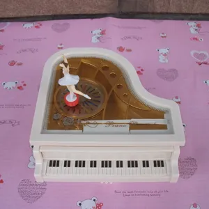 Piano music box with rotating ballerina dancing girl, white aesthetic musical gift for birthday cake.