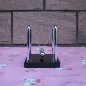 Small Newton's Cradle balance balls metal physics toy decorative desk ornament for home office decor.