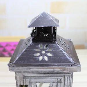 Vintage wooden candle lantern detail shot, hollow floral metal roof design for home decor.