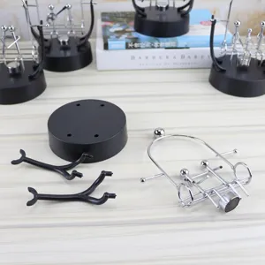 Kinetic art balance toy parts detail view, creative metal desk ornament and office decor setup.