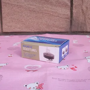Close up of magnetic sculpture desktop toy packaging box showing strong magnetic base features.