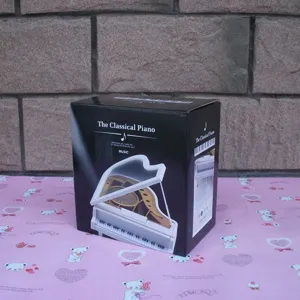 Miniature piano music box packaging display, classic design gift box for home decor and birthdays.