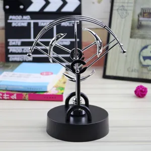 Detailed close-up shot of the silver dolphin perpetual motion desk toy, science decor.