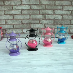 Detailed view of colorful gel candle lantern ornaments in various colors for home decor.