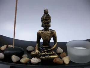 Resin Buddha incense burner holder set with pebbles and candle tray for home zen decor.