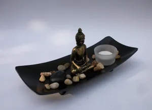 Zen desktop ornament set featuring a resin Buddha statue, tray, candle holder, and stones.