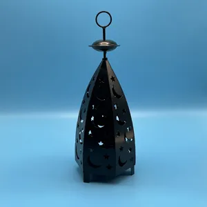 Detailed view of black metal star moon hollow lantern candle holder for desktop decor.