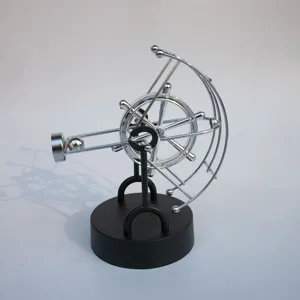 Close-up detail of silver and black metal perpetual motion celestial globe physics toy desk decor.