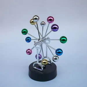 Detailed close-up of the creative colorful metallic perpetual motion desk toy sculpture.