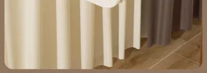 Elegant home scene detail showcasing soft fabric curtains and warm wooden flooring textures.