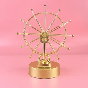 Golden metal Ferris wheel perpetual motion machine desk ornament, creative office and home decor.