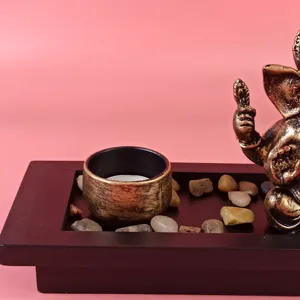 Detailed view of the elephant god Ganesha statue with candle holder and tray set for decor.