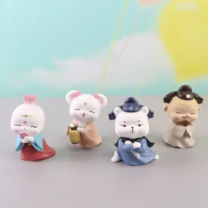 Close-up detail of cute ancient Chinese style resin hanfu figurines for desktop decor.