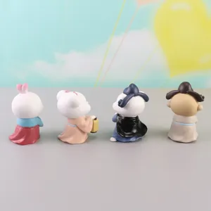 Detail view of four cute ancient Chinese style resin figurines, Hanfu character ornaments.