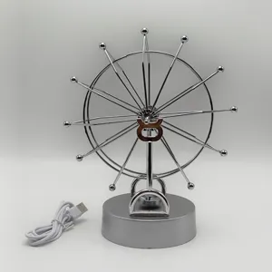 Silver metal Ferris wheel perpetual motion machine balance toy with USB cable for office desk decor.