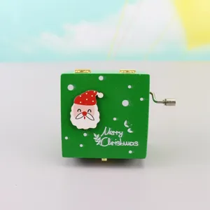 Close-up of wooden Christmas music box with cute Santa Claus face and hand crank mechanism.