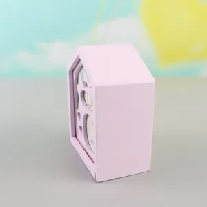Detailed view of a charming pink wooden house-shaped music box, perfect creative gift.