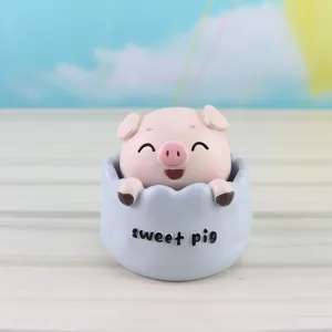 Cute resin pig figurine detail view, adorable shaking head design for car or desk decor.