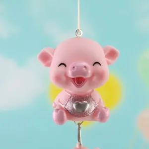 Cute pink pig hanging ornament detail showing cute face and silver heart charm pendant.