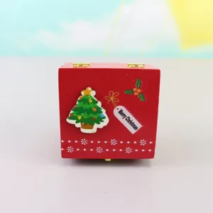 Wooden Christmas music box detail view, red festive design with cute tree and holiday tag.