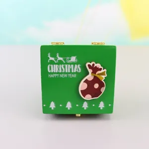Wooden Christmas music box detail view, featuring a green festive design for holiday decor.