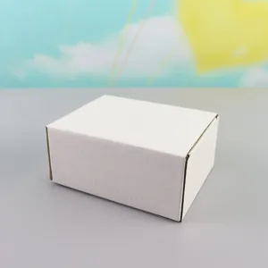 Detailed view of the plain white cardboard packaging box, clean surface and neat paper fold.