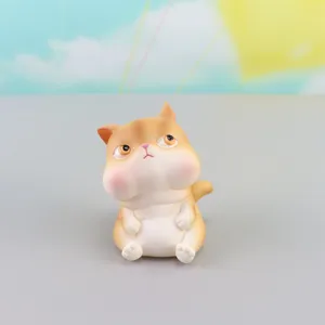 Cute chubby cat figurine close-up, resin cartoon desk ornament, lovely pouting pet decor.