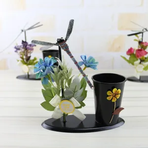 Creative iron dragonfly pen holder with blue flowers for office desktop decoration craft.