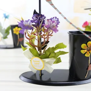 Creative iron art pen holder featuring a spinning dragonfly, decorative flowers, and cute tag.