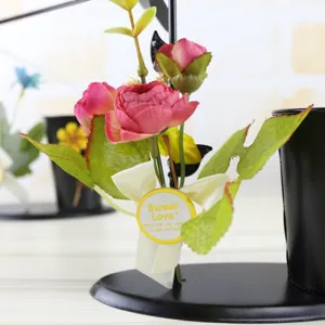 Close-up detail of the rotating iron pen holder with cute artificial flowers and ribbon.