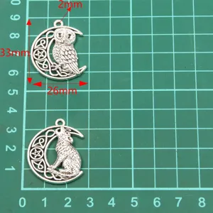 Owl and wolf moon metal charms detail, antique silver DIY jewelry making accessories.