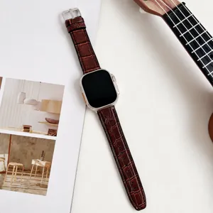 Detailed view of brown bamboo grain silicone watch strap, compatible with Apple Watch.