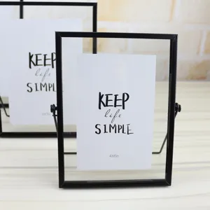 Modern metal glass photo frame detail, minimalist rotating picture stand for desktop decor.