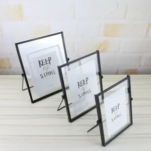 Geometric glass metal picture frame detail showing modern black desktop photo display stand.