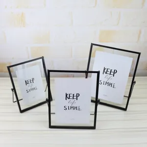 Geometric glass photo frame set with black metal edges, ideal for elegant home decor.