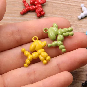 Detailed shot of colorful zinc alloy balloon dog charm pendants, DIY jewelry making accessory.