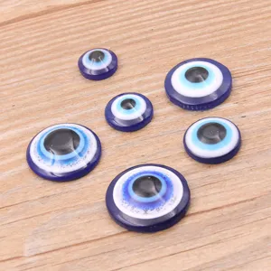Close-up detail shot of round resin evil eye cabochons, ideal for DIY phone case decoration.