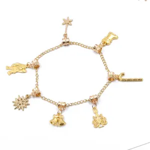 Gold Christmas charm bracelet detail showcasing various holiday metal pendants and linked chain.