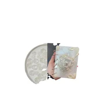 Mixed acrylic resin flatback rose charms and decorative handmade journal notebook.