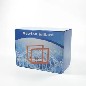 Detailed view of the Newton cradle balance balls packaging box, physics desktop toy display.