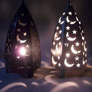 Detail view of vintage iron star moon hollow candle holders casting beautiful light shadows.