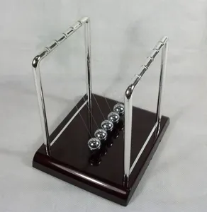 Primer plano detallado de las bolas de equilibrio de la cuna de Newton sobre base de madera.