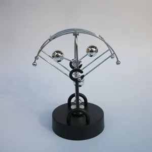 Close-up detail of kinetic sculpture metal balls desk toy perpetual motion office decor.
